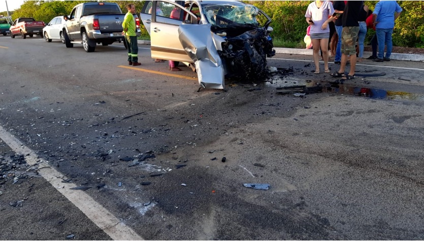 Imagem da cena do acidente com carro com a frente destruída.