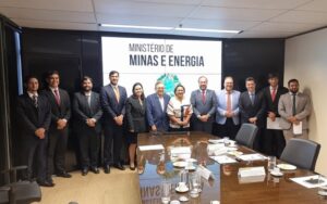 Imagem da sala de reunião no Ministério de Minas e Energia com participantes em pé posando pra foto.